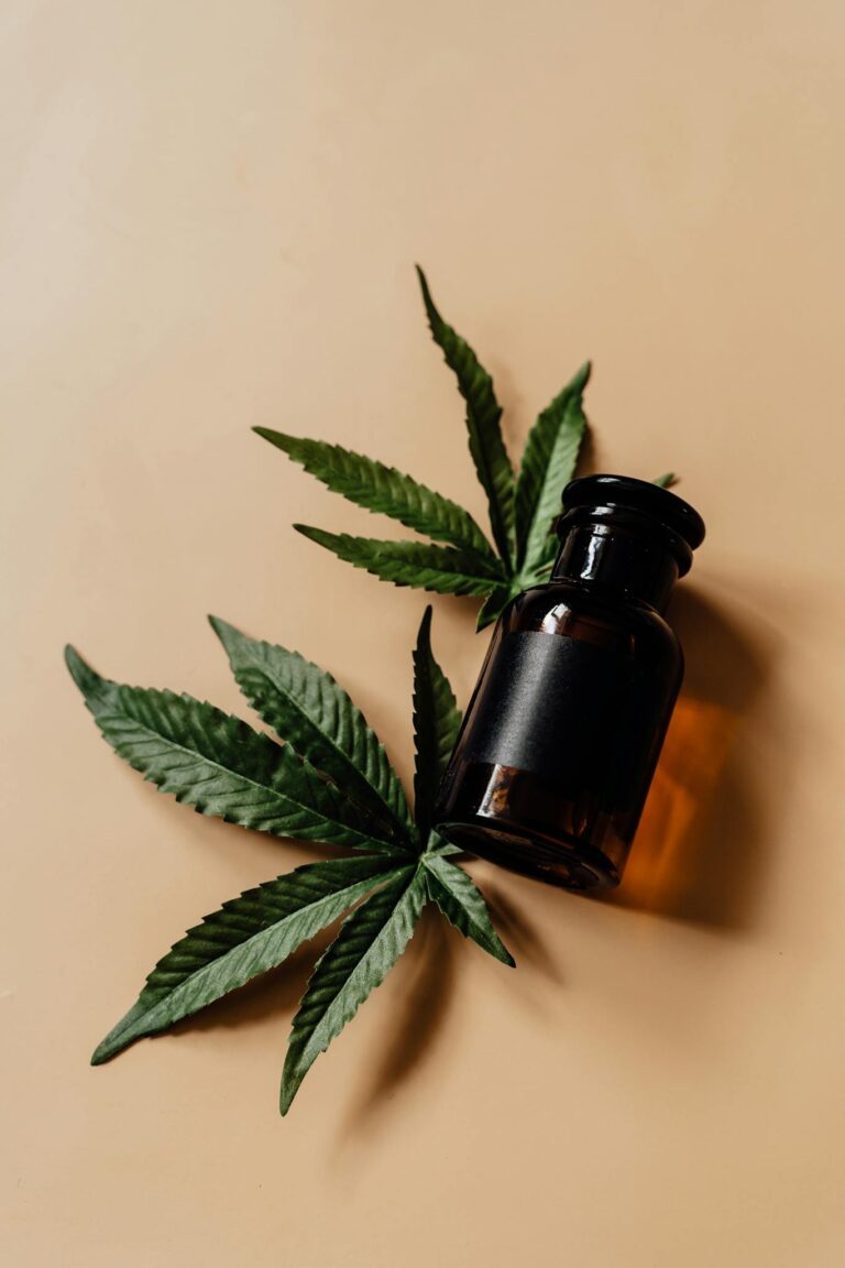 Brown glass bottle with cannabis leaves, highlighting natural healthcare and medicinal themes.
